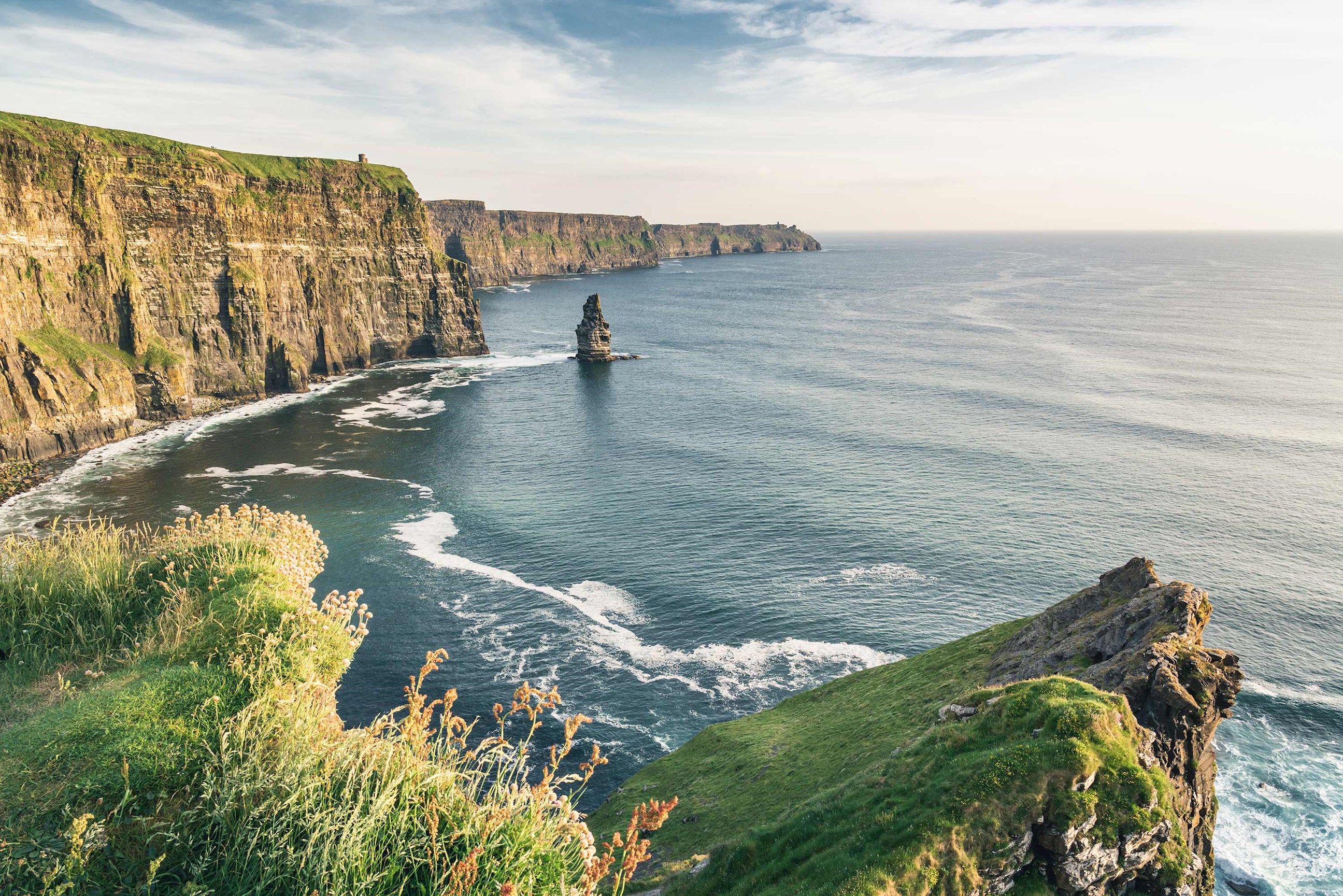 Expansive view of rocky cliffs and ocean in Cliffs of Moher, Ireland
