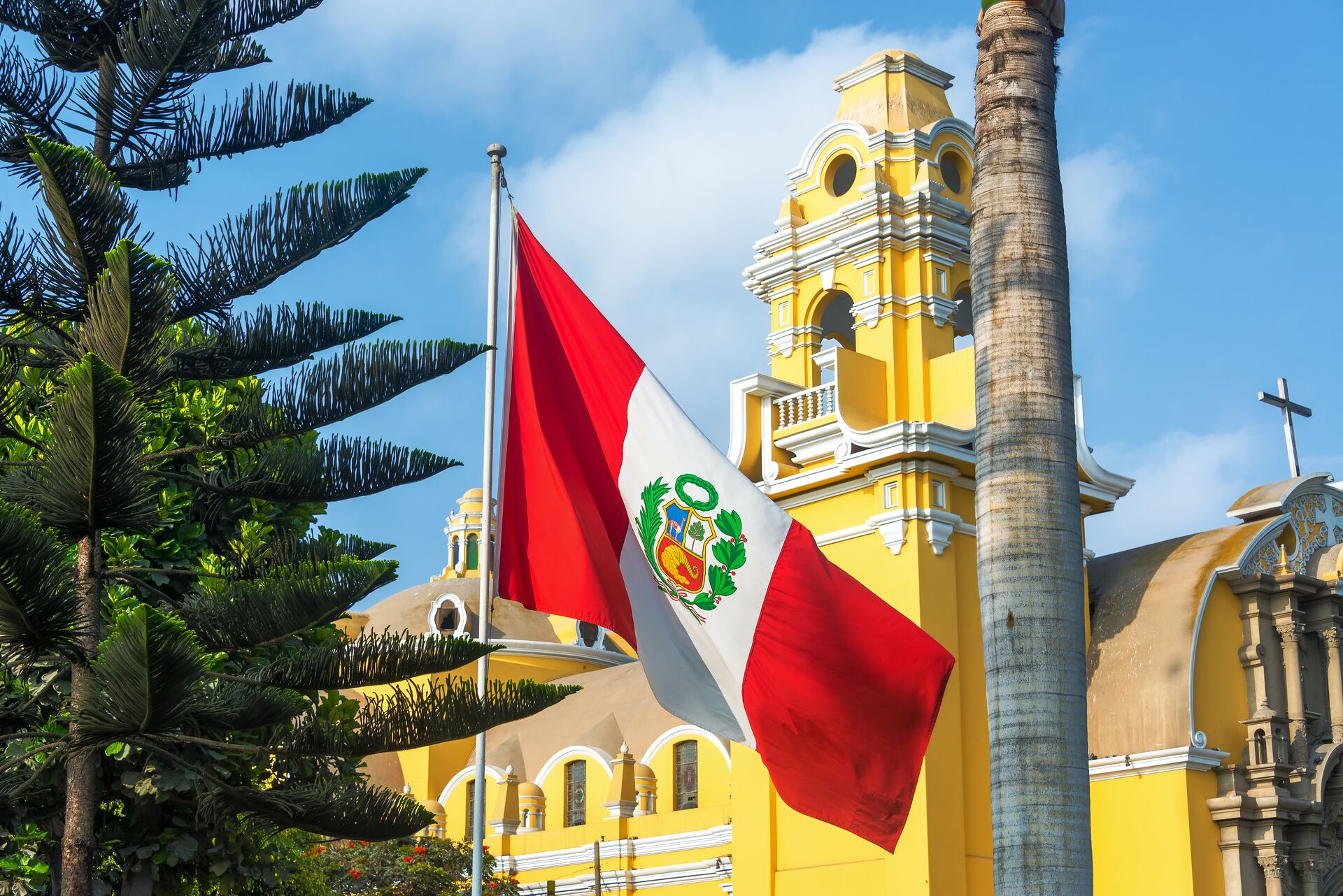Monastery Of San Francisco with a Peruvian flag in front of it in Lima, Peru