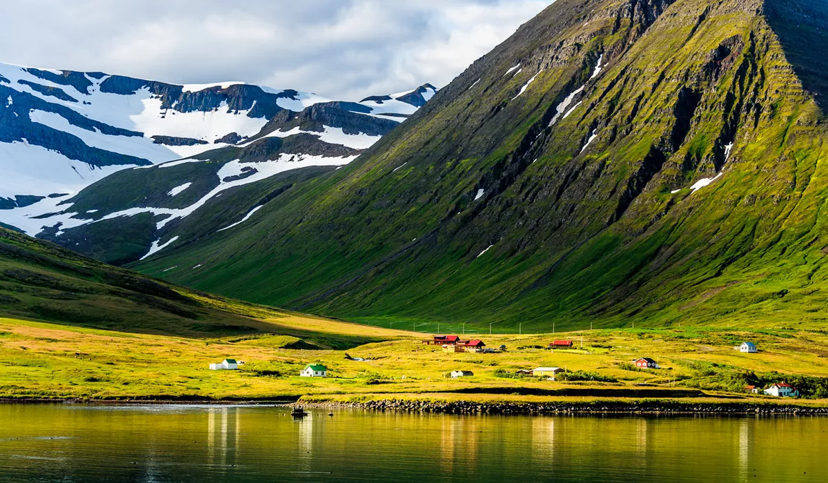 Scandinavia Fjord Village with green hills and mountains