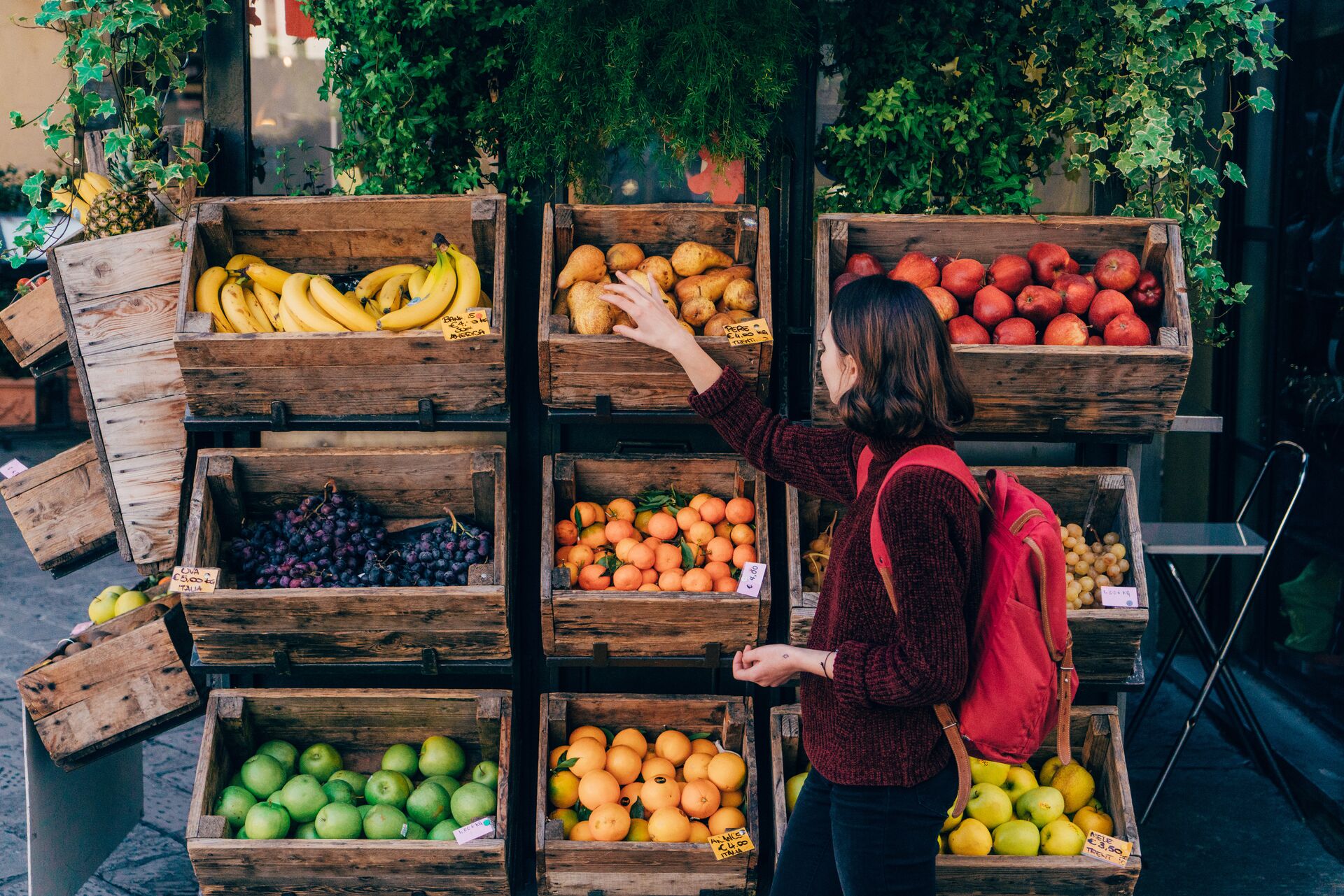 Woman picking fresh fruit from a local fruit stall