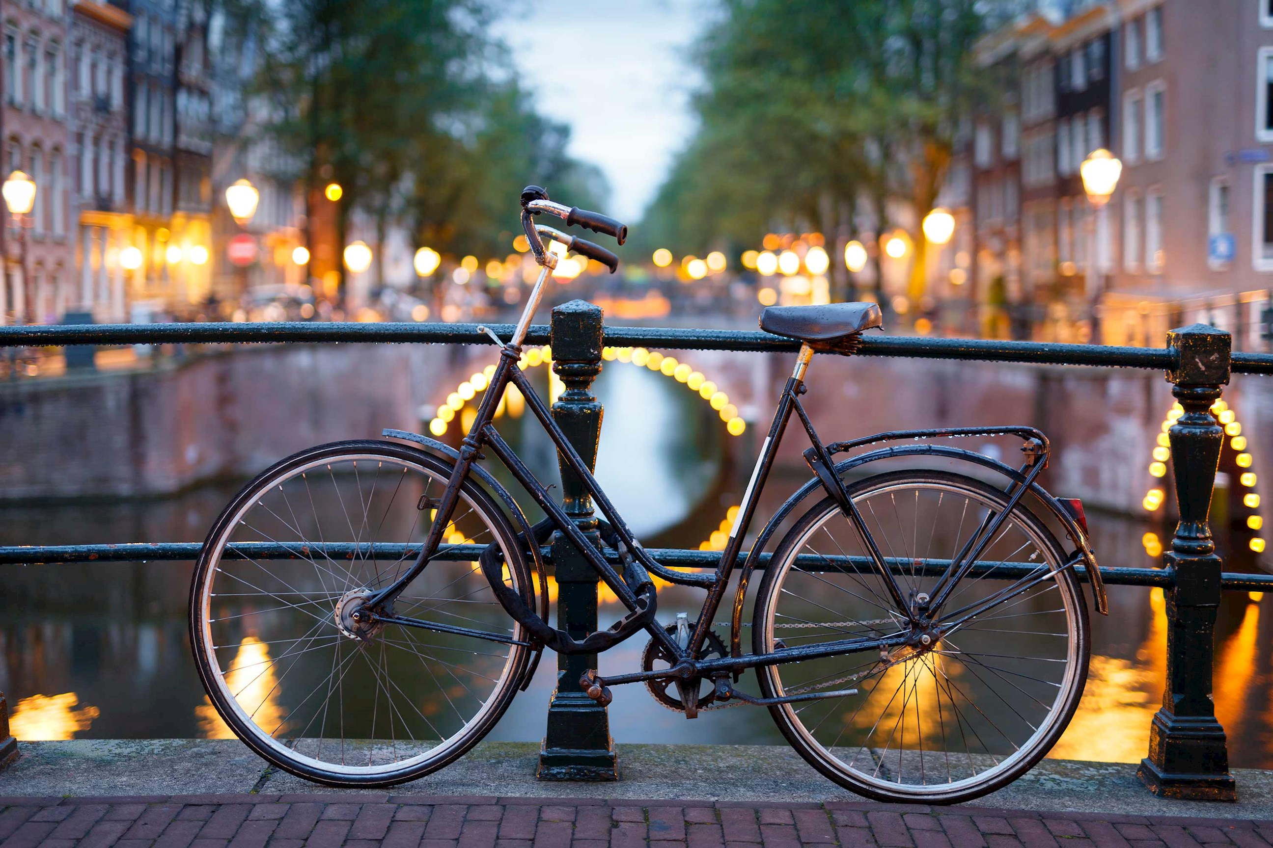 A bicycle on a bridge overlooking a canal in Amsterdam, Netherlands