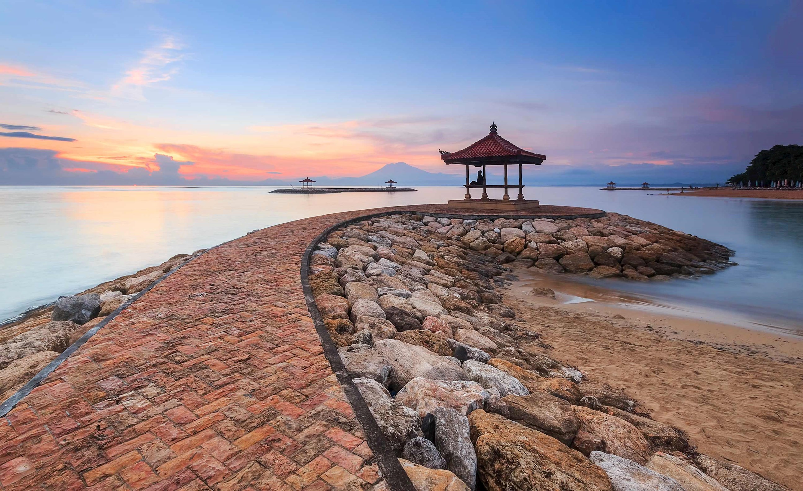 Stone pathway to pavilion at sunset on Karang Beach, Sanur