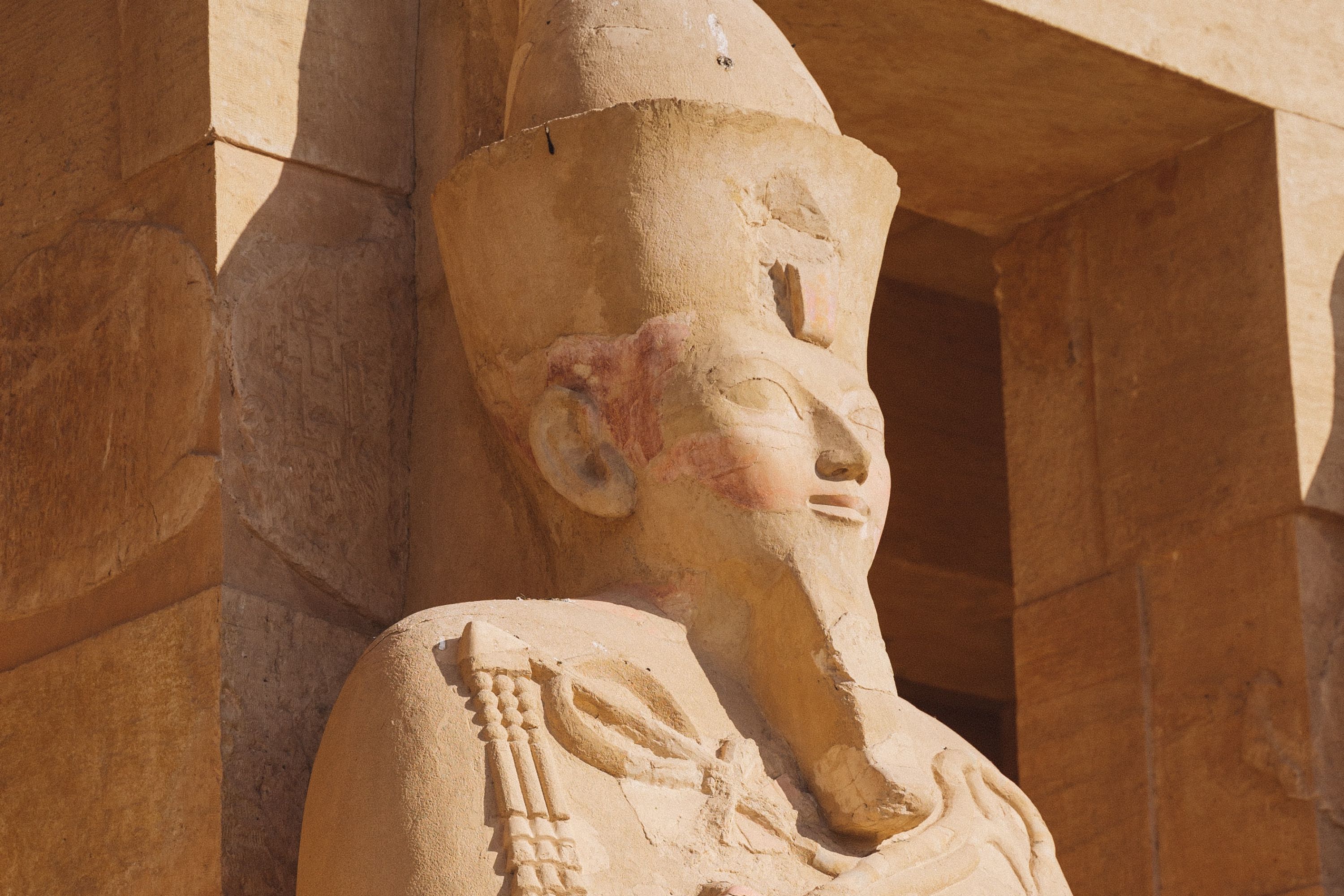 An ancient statue at the entrance of a tomb in Egypt
