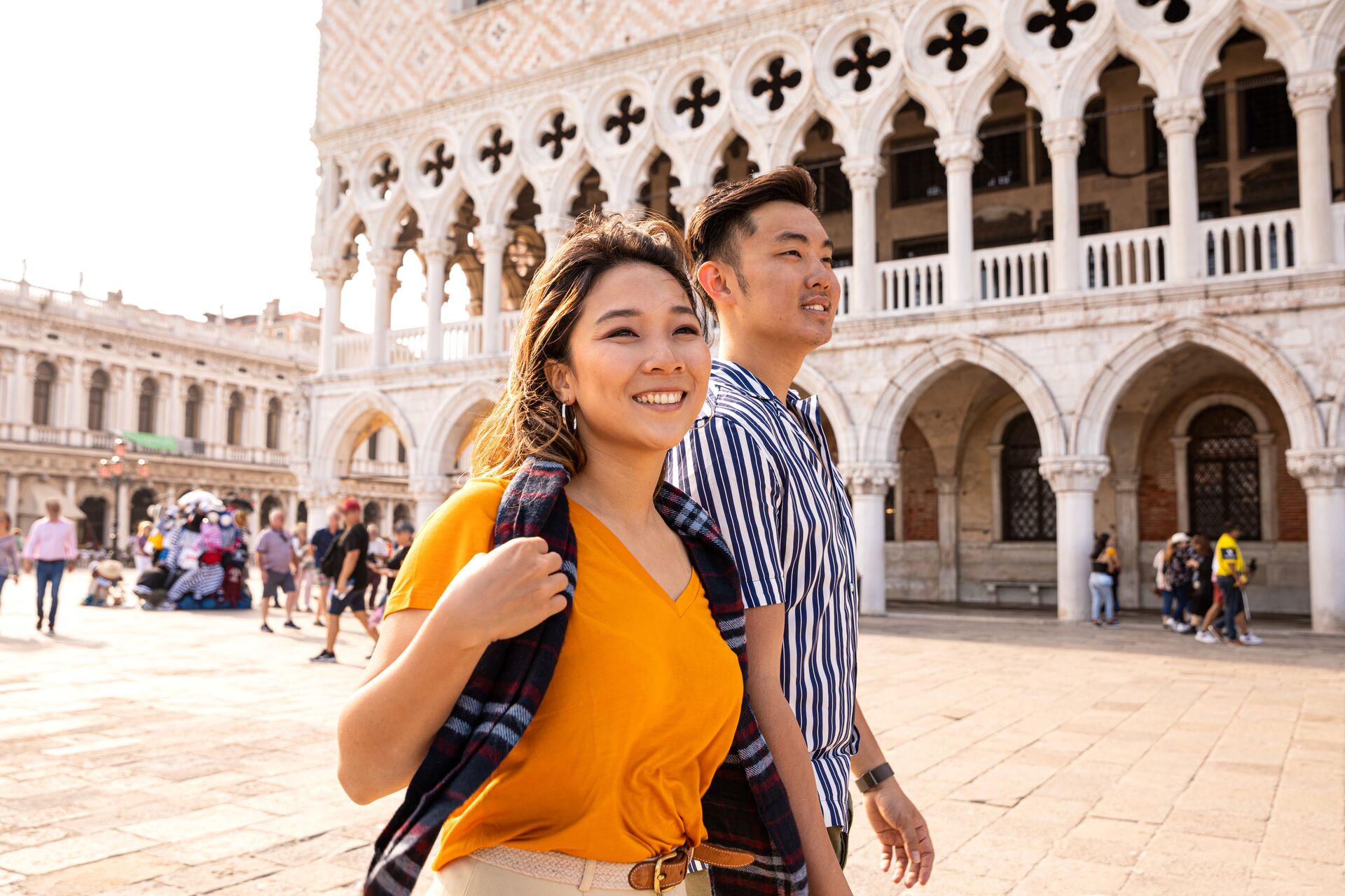 Asian couple in Venice Italy walking through the city