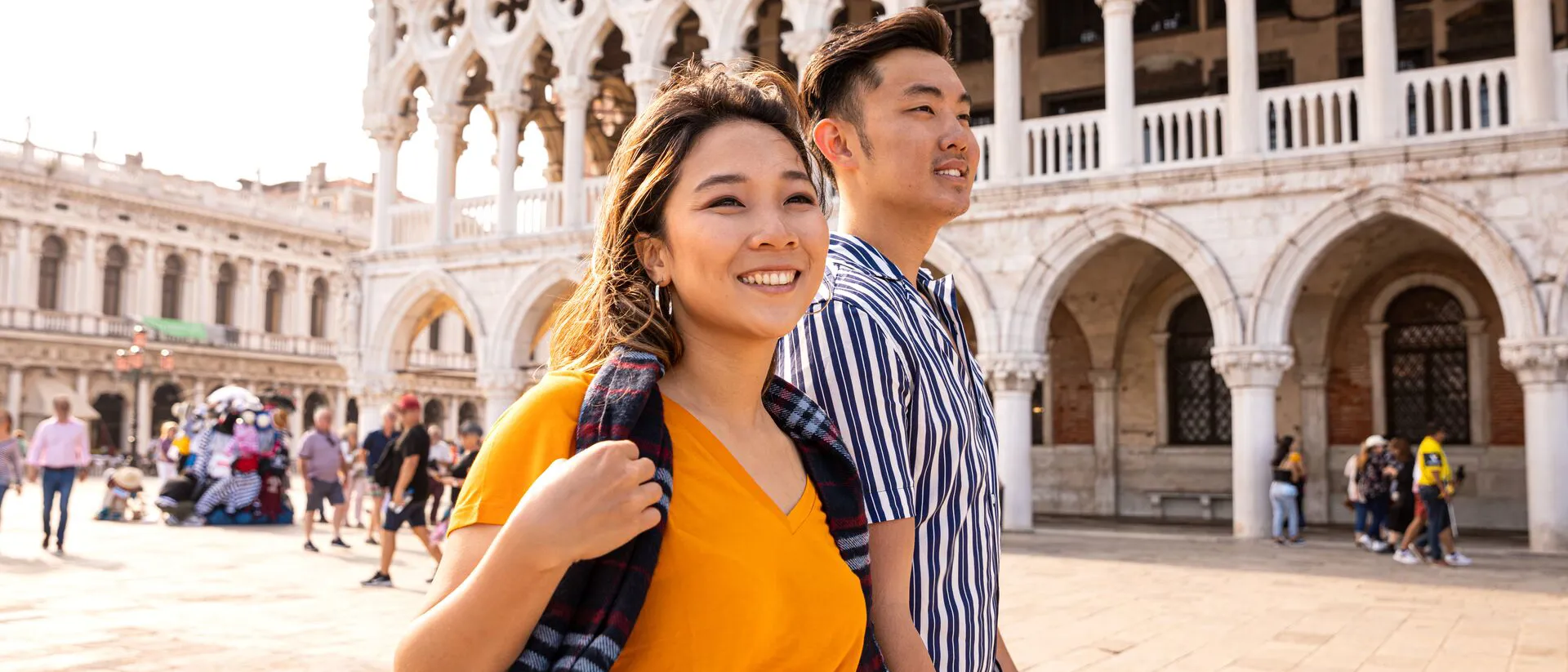 Asian couple in Venice Italy walking through the city