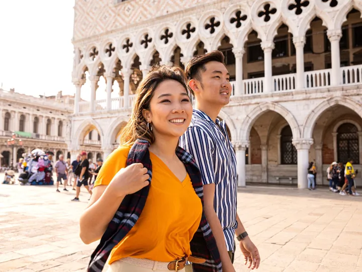 Asian couple in Venice Italy walking through the city