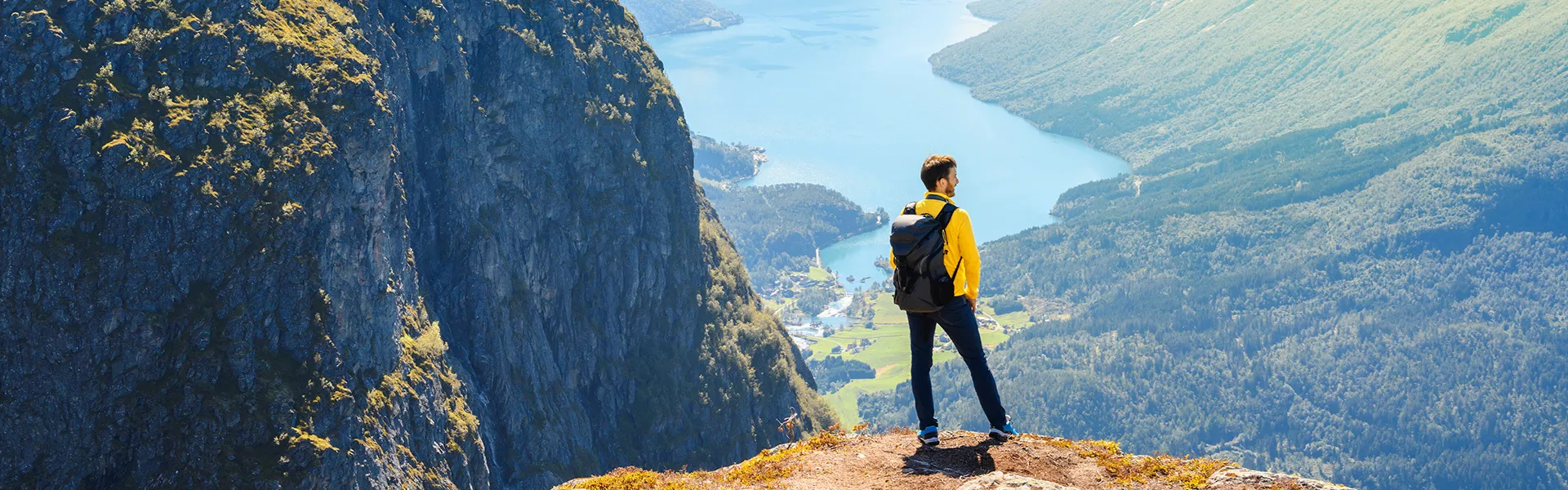 Tourist admiring the view from the top of Loen, Norway