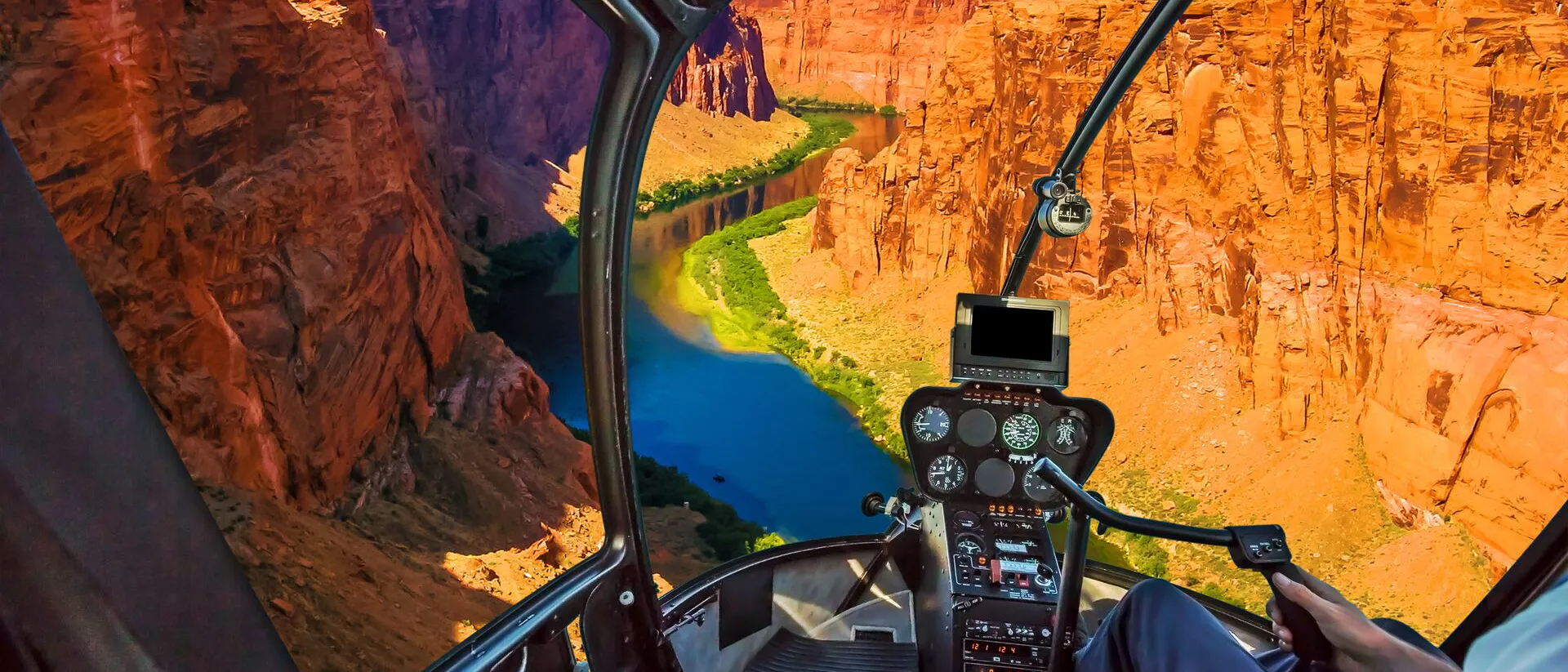 Man flying helicopter through the Grand Canyon in Arizona, USA