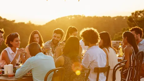 Tour group dining around an outside table