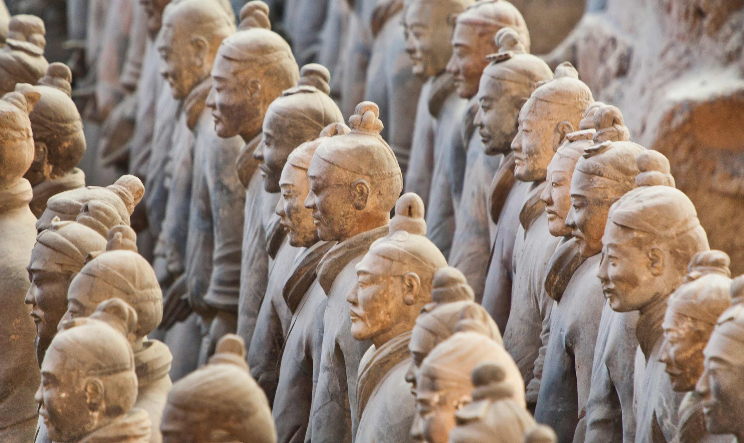 Terracotta Army statues arranged in rows inside excavation pit in Xi’an, China