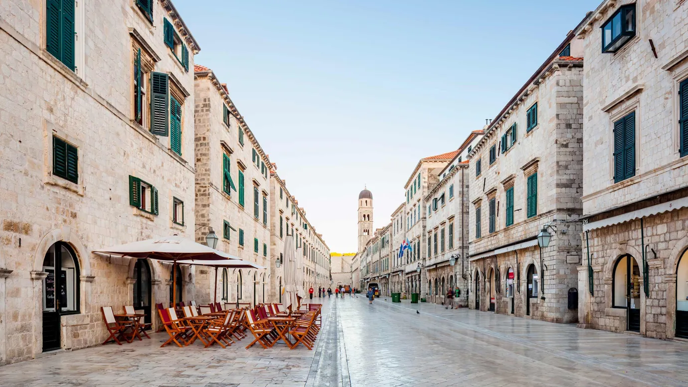 A stone-paved Stradun street with cafes in Dubrovnik, Croatia