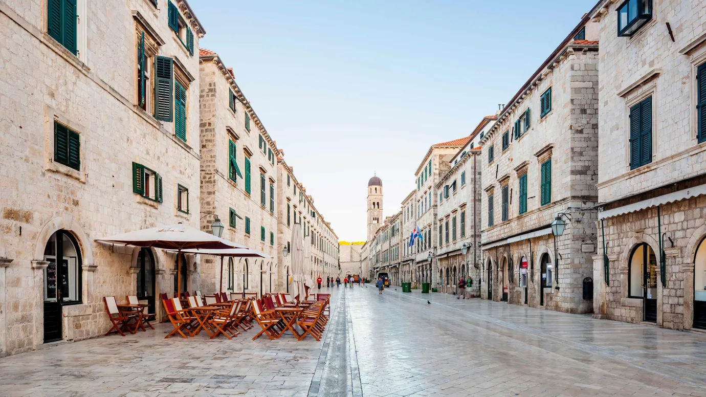 A stone-paved Stradun street with cafes in Dubrovnik, Croatia