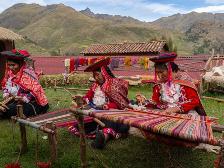 Female Weavers In Traditional Local Dress Weaving Colourful Alpaca Wool