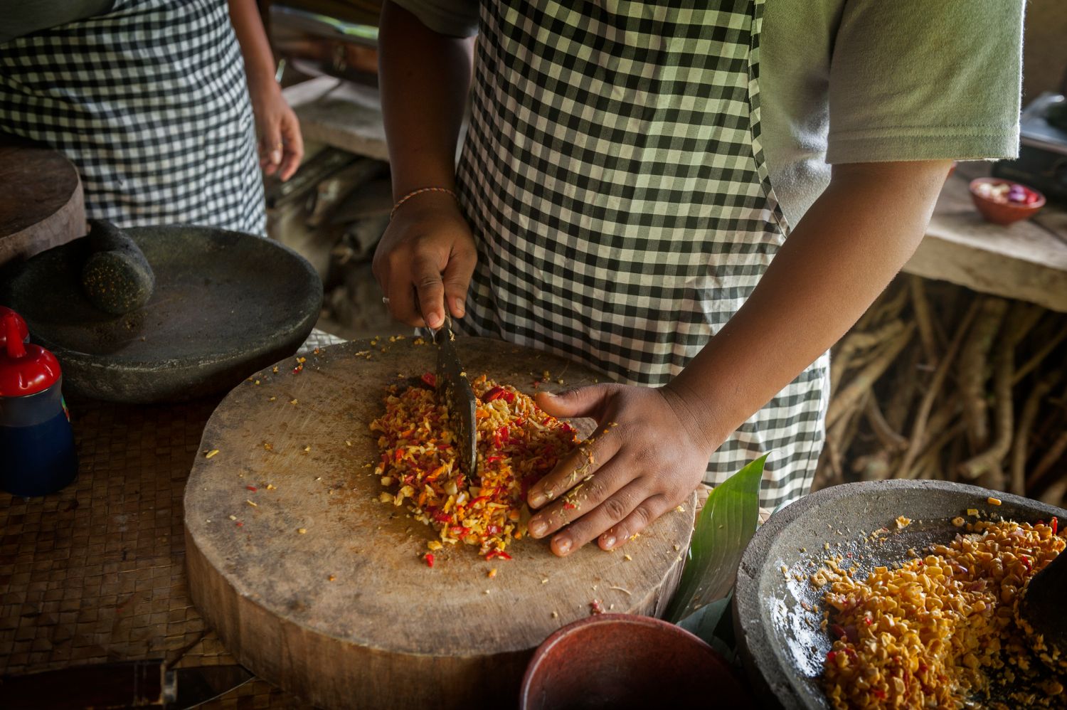 Someone cutting red chillies on a wooden block, Ubud Market Cooking Class Bali Indonesia
