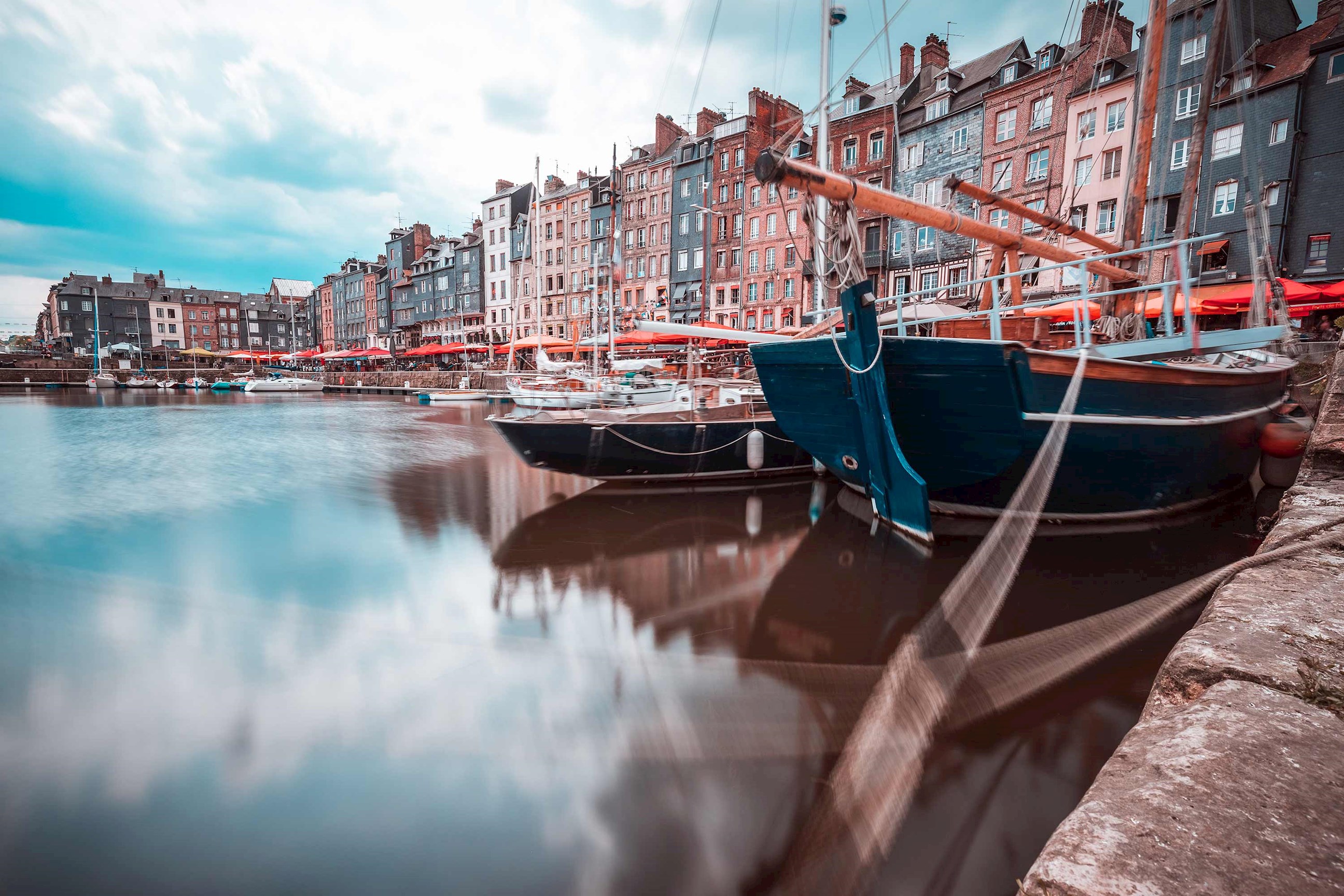 Close view of sailboats along a waterfront in Honfleur, France