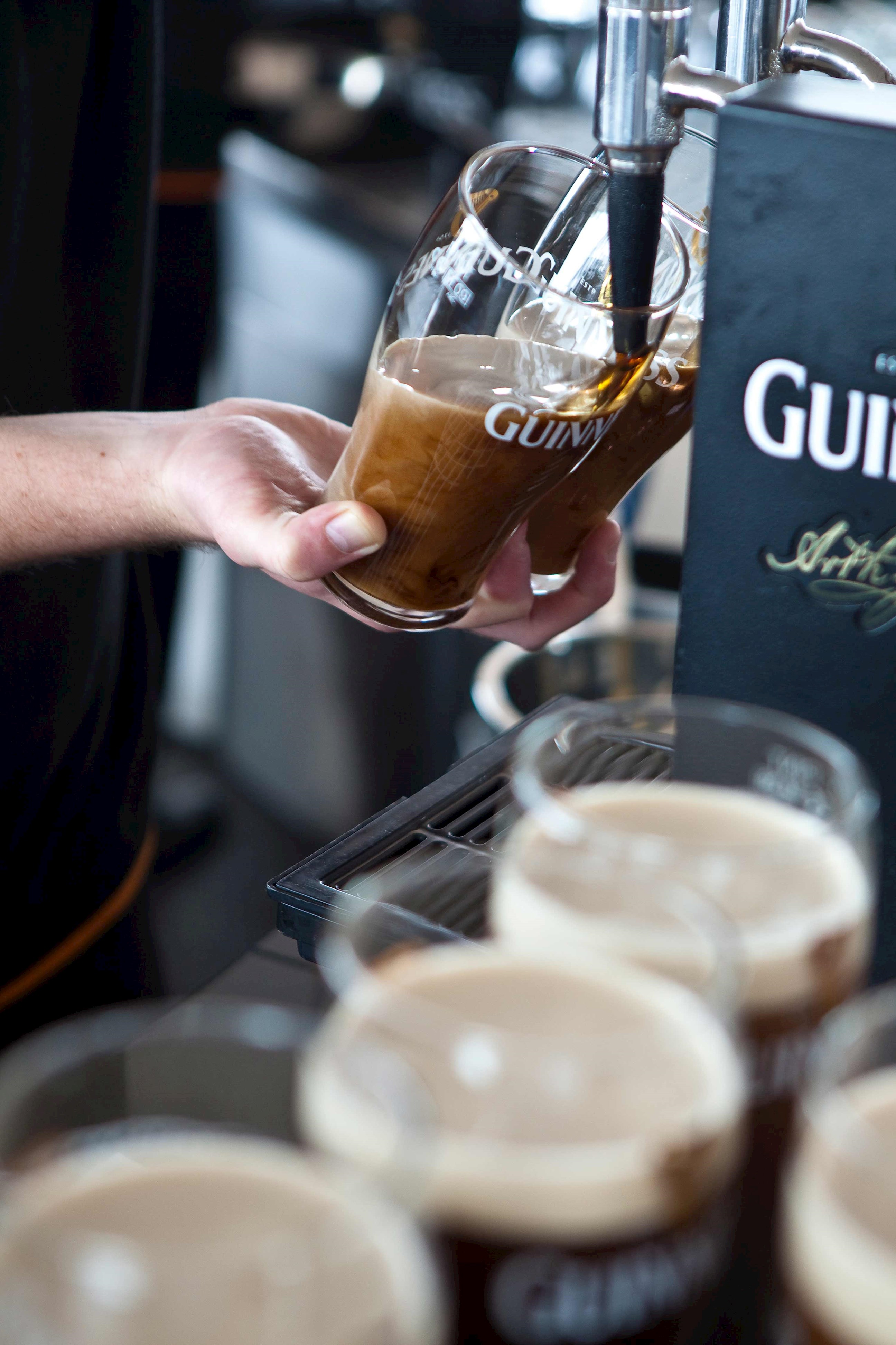 Close-up of a beverage flowing into a tilted pint glass in Dublin, Ireland