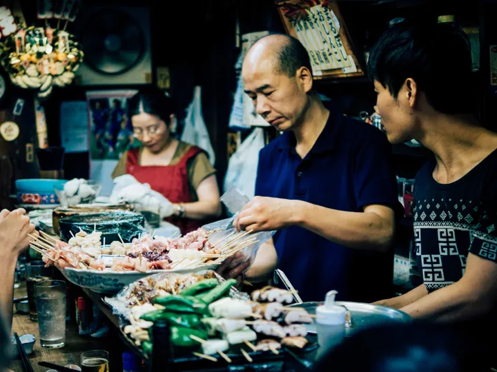 A market stall in Japan selling food on skewers