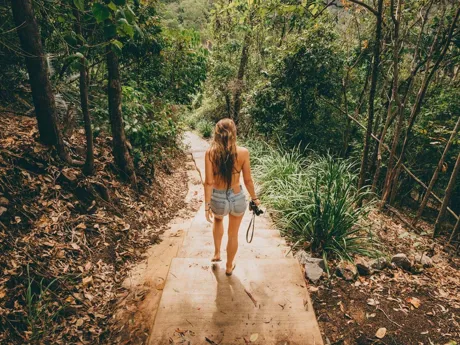 A woman walking through the forest in Cairns