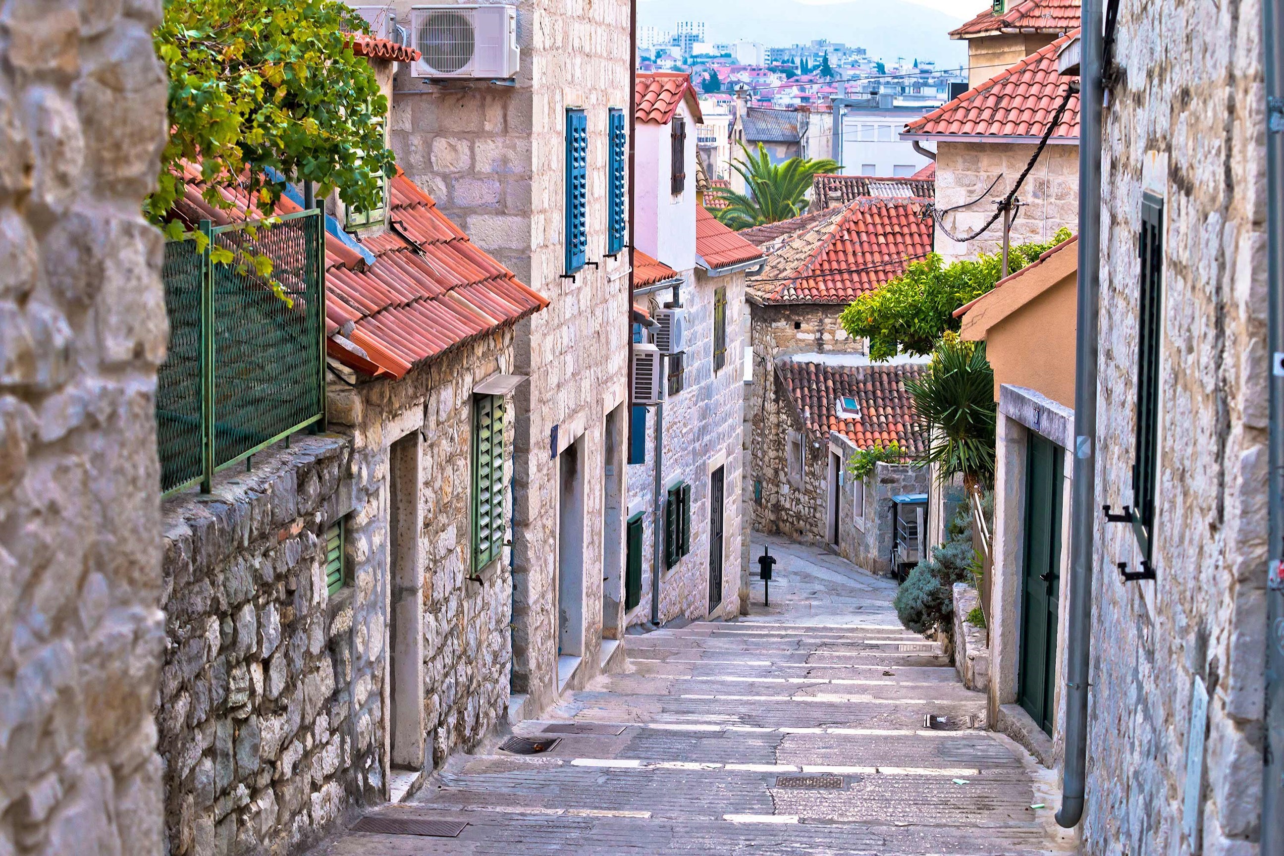 A narrow stone alley with houses in Split, Croatia