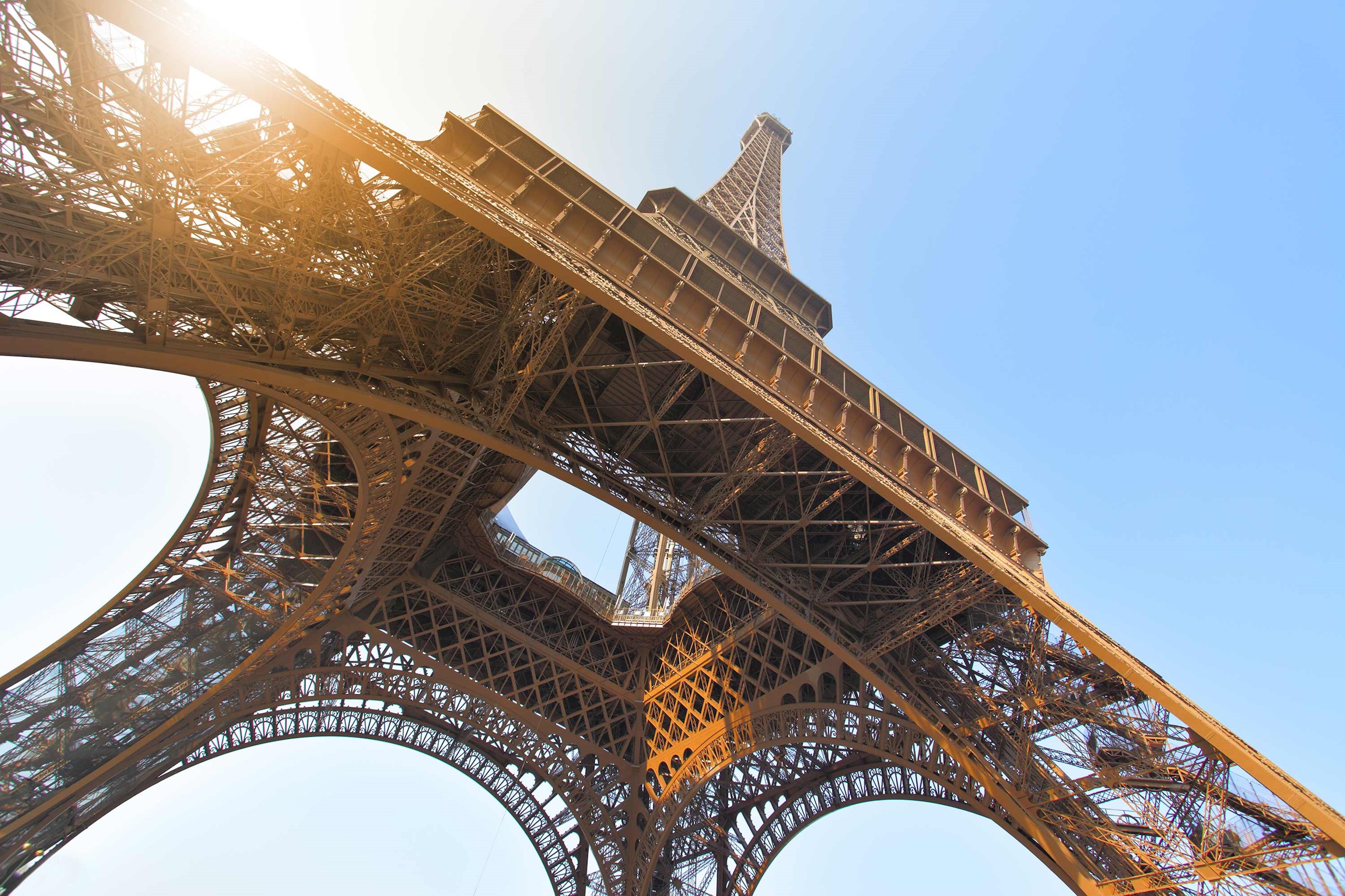 Iconic Eiffel Tower view from below against a clear sky in Paris, France