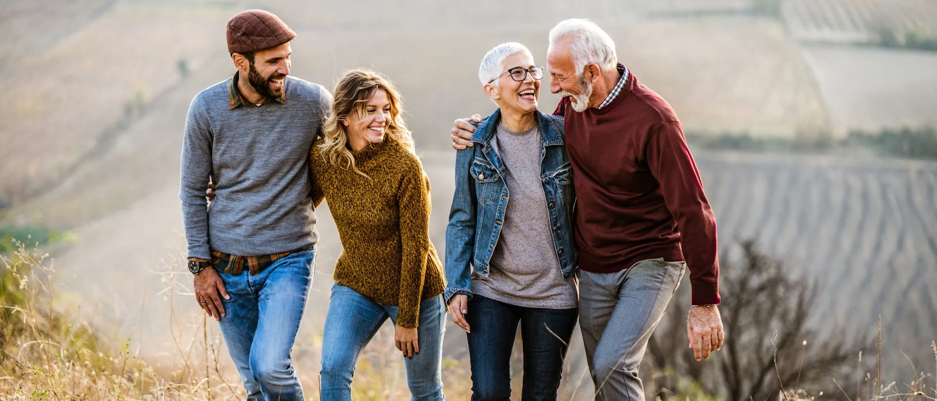 Young couple talking to seniors while walking on an Autumn Day