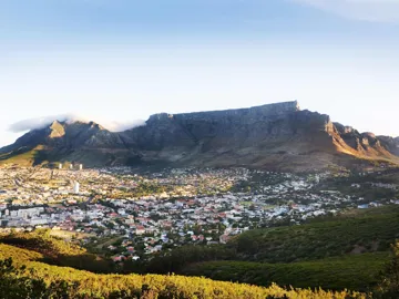 Expansive city view of a flat mountain by green hills in Cape Town