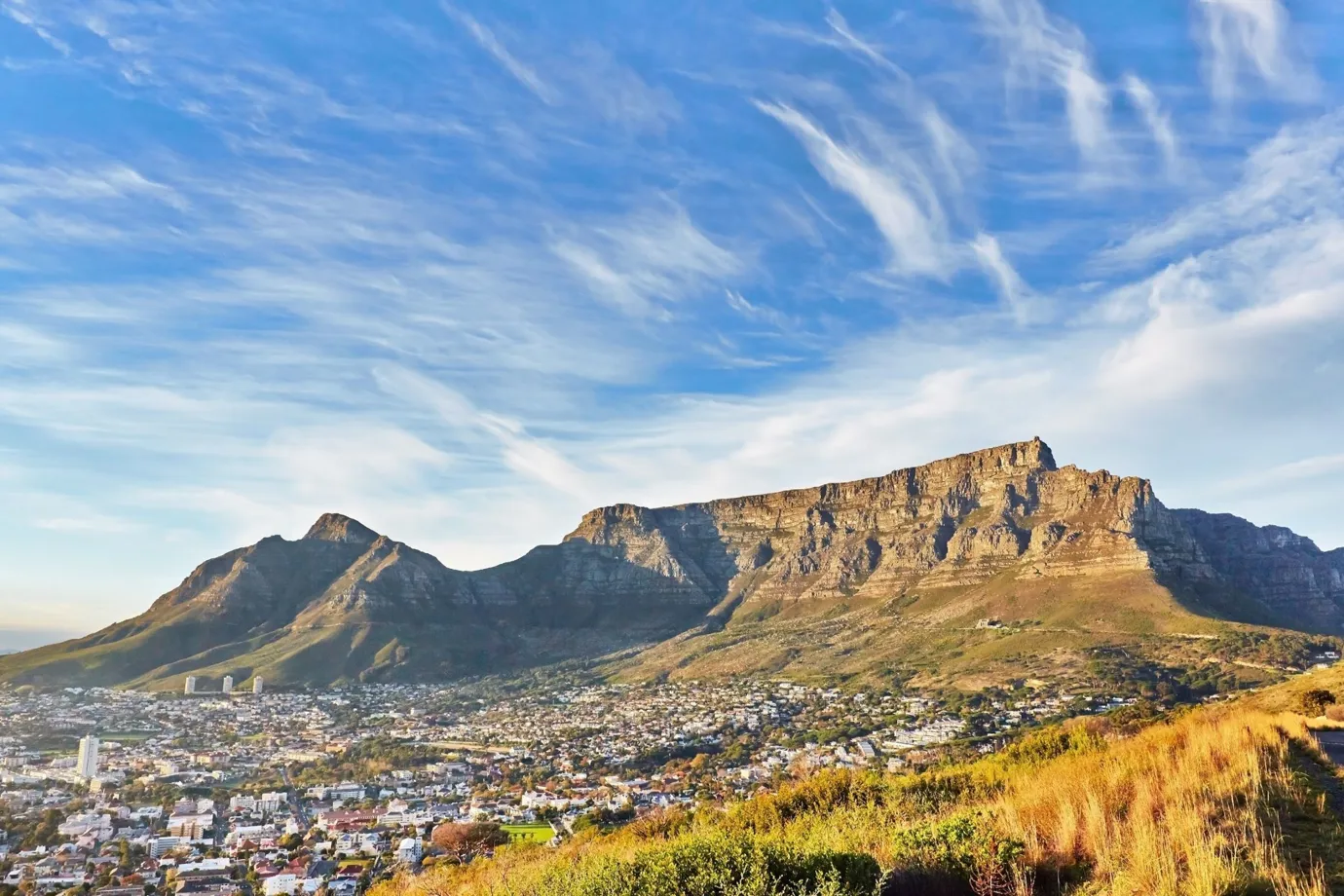 A view of Table Mountain in Cape Town with buildings visible along its base.
