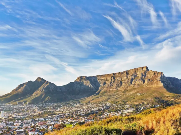 A view of Table Mountain in Cape Town with buildings visible along its base.