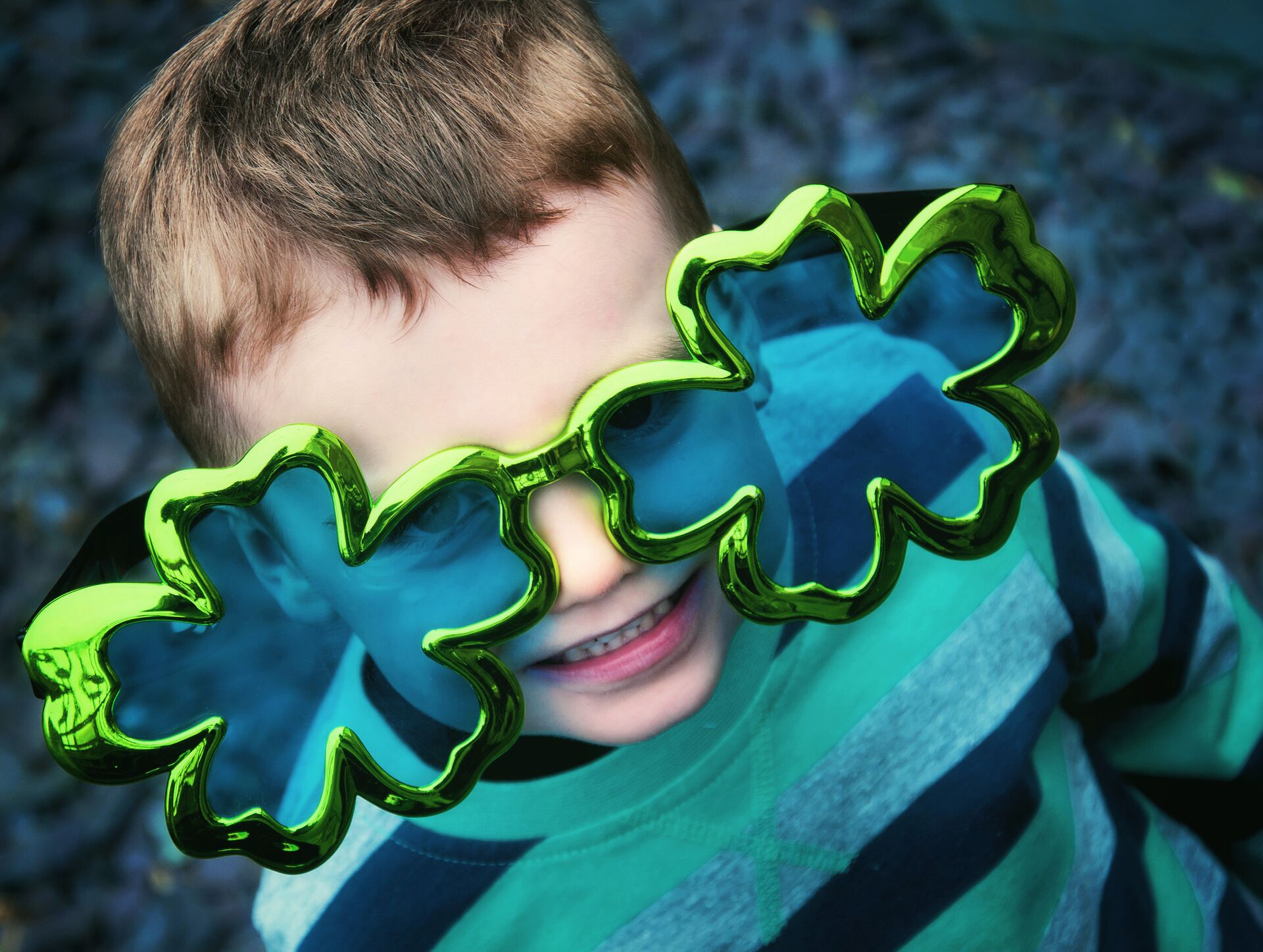 Child wearing giant Shamrock glasses