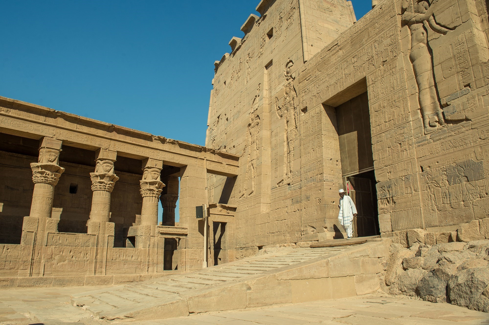 Scenic view of an ancient temple beneath a clear sky in Aswan, Egypt.