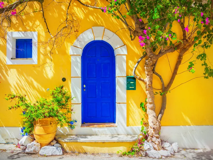 Blue door against a yellow building