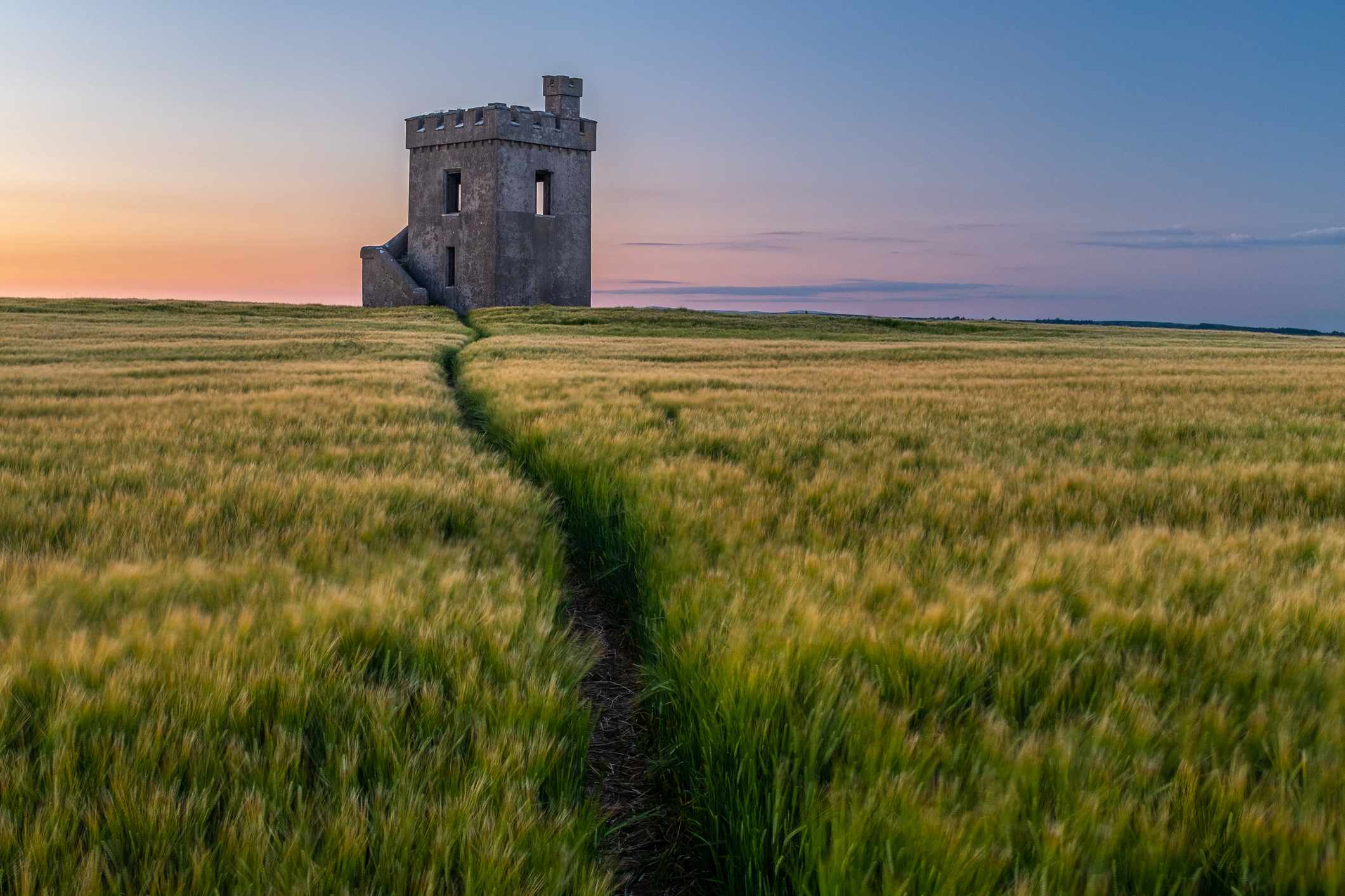 Single building in a field in Waterford at sunset