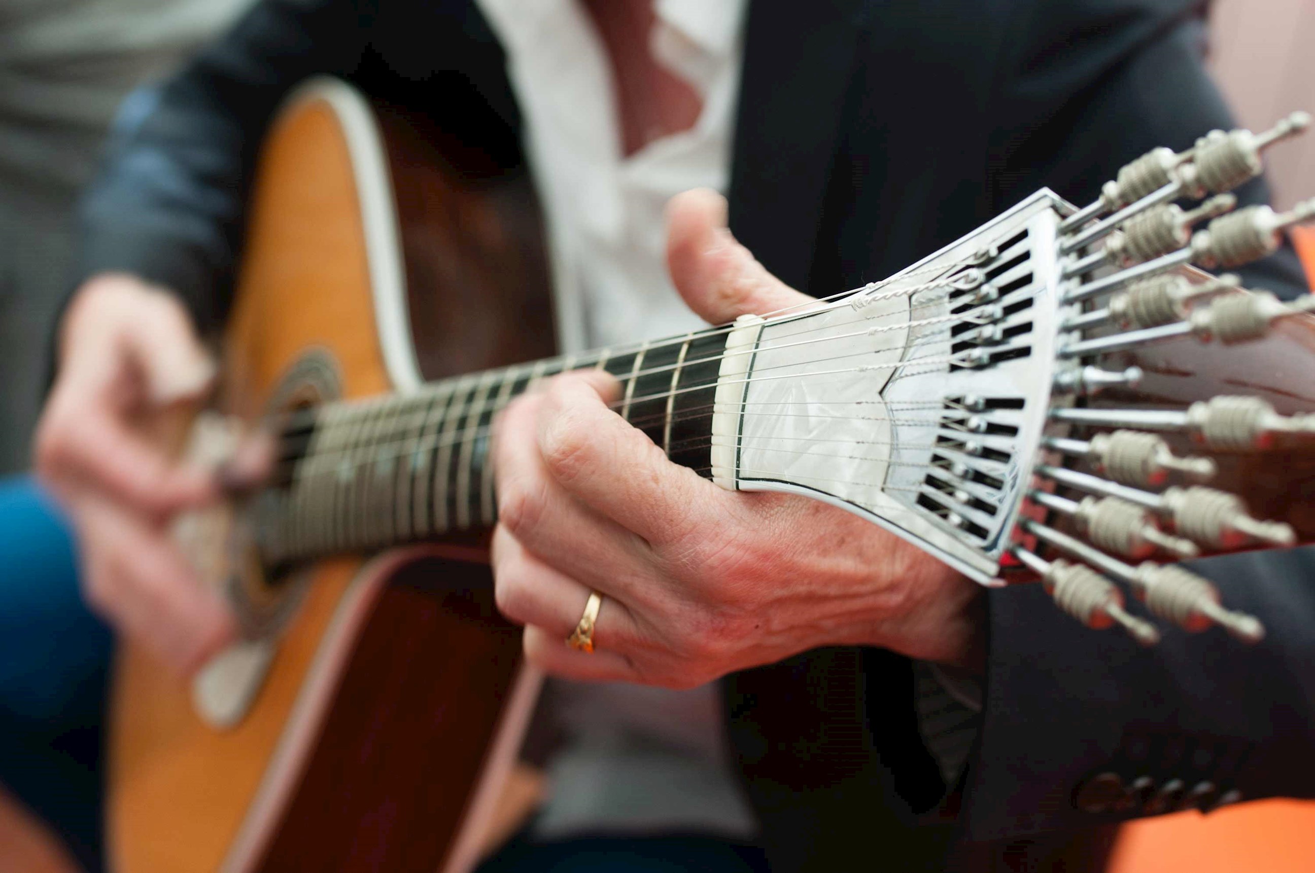 Man playing acoustic guitar at dinner in Lisbon, Portugal