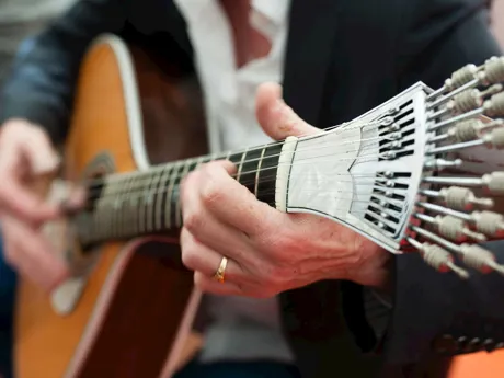 Man playing acoustic guitar at dinner in Lisbon, Portugal