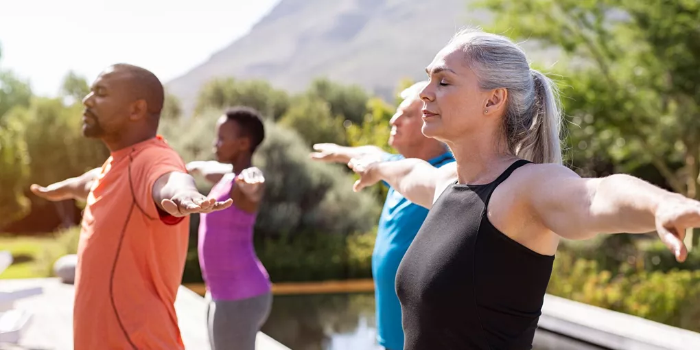 Group of guests practicing breathing exercises 