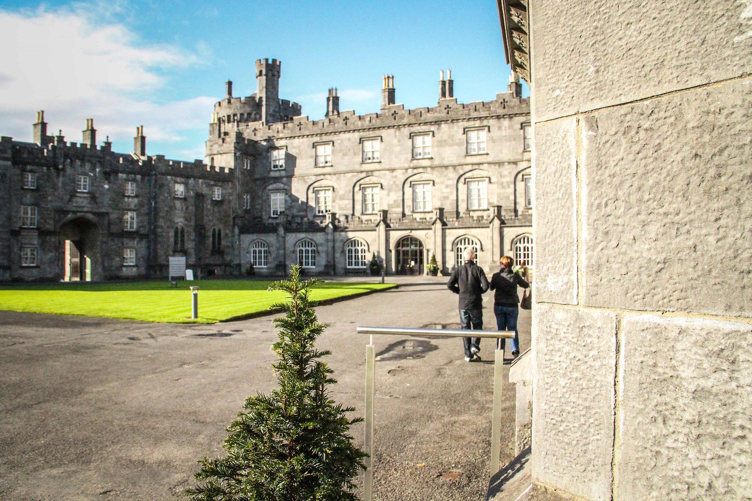 A stone courtyard castle under the blue sky in Kilkenny, Ireland