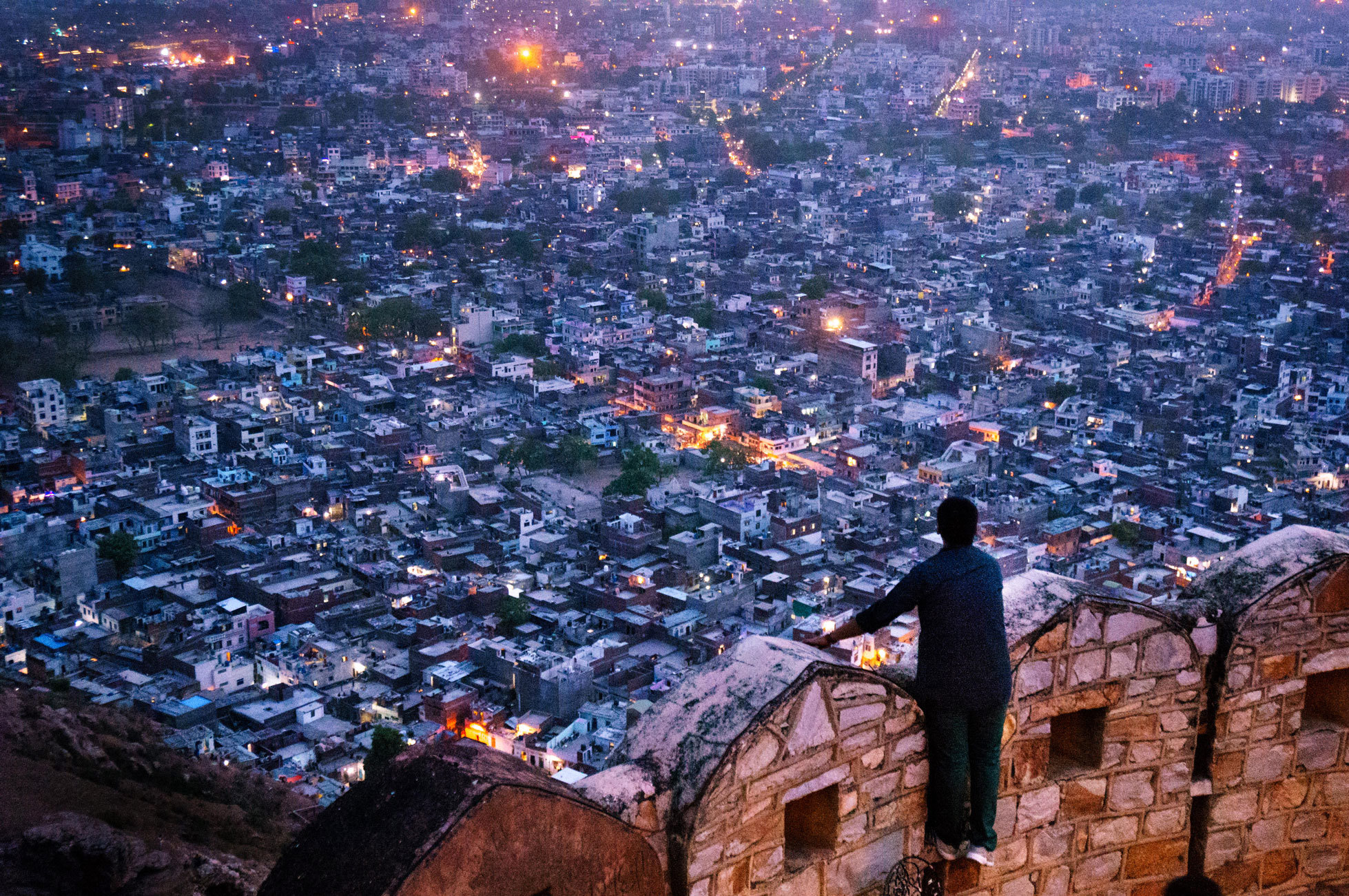 Panoramic view of Jaipur city from historic fort wall at dusk 