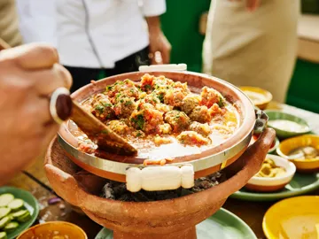 Close-up of Moroccan tagine being stirred