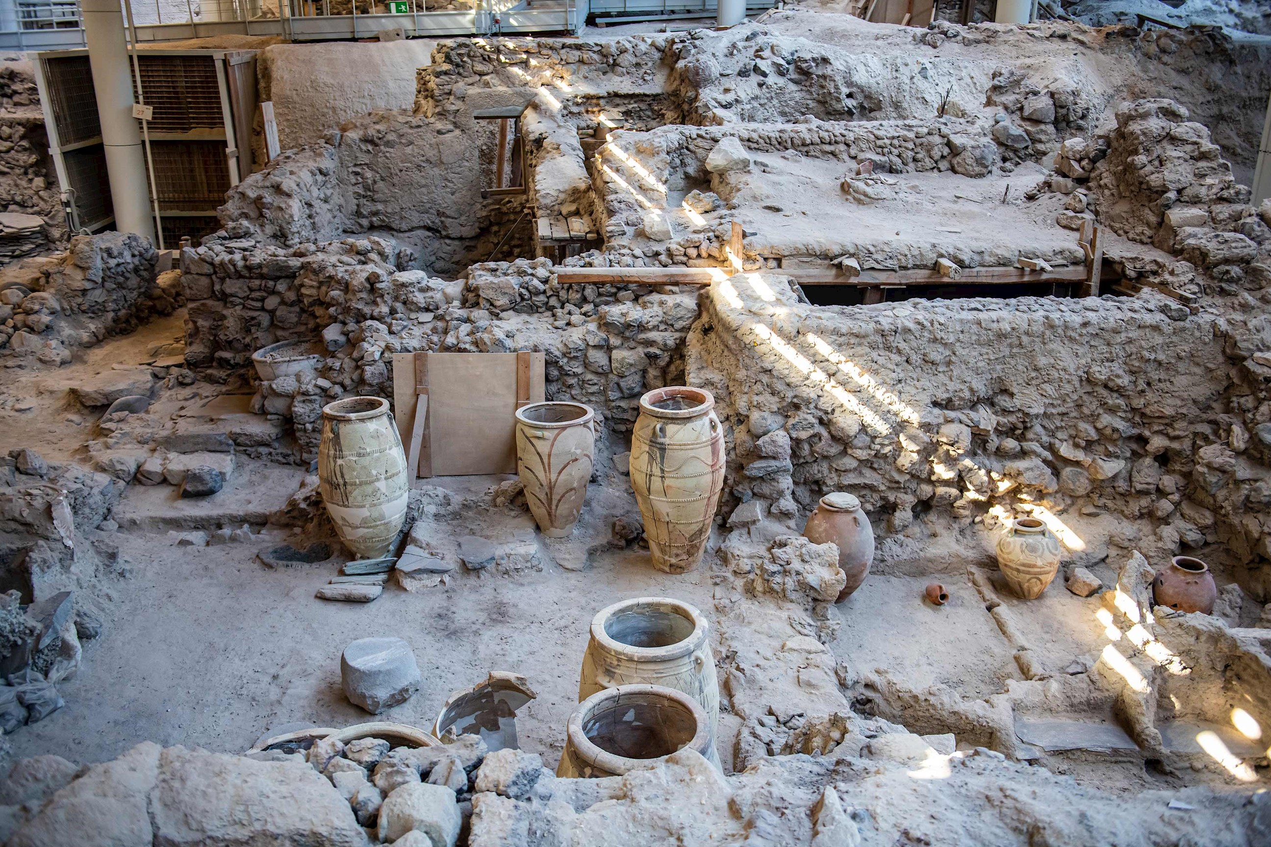 Ancient ruins with stone artefacts and excavation site, Santorini, Greece