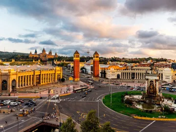 Aerial view of Plaça d’Espanya with Venetian Towers, fountain and National Palace at sunset in Barcelona, Spain