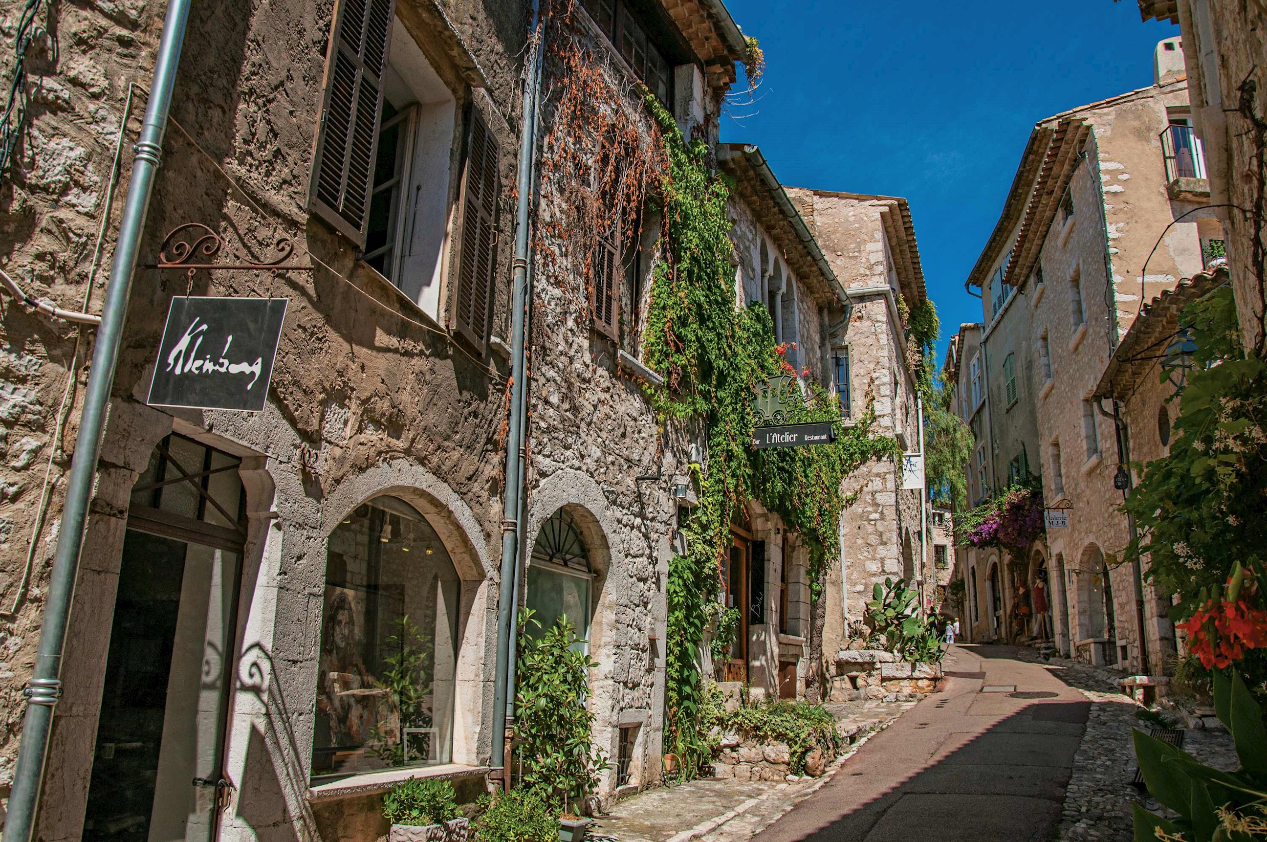 External view of a narrow street with stone buildings in Saint Paul De Vence, France