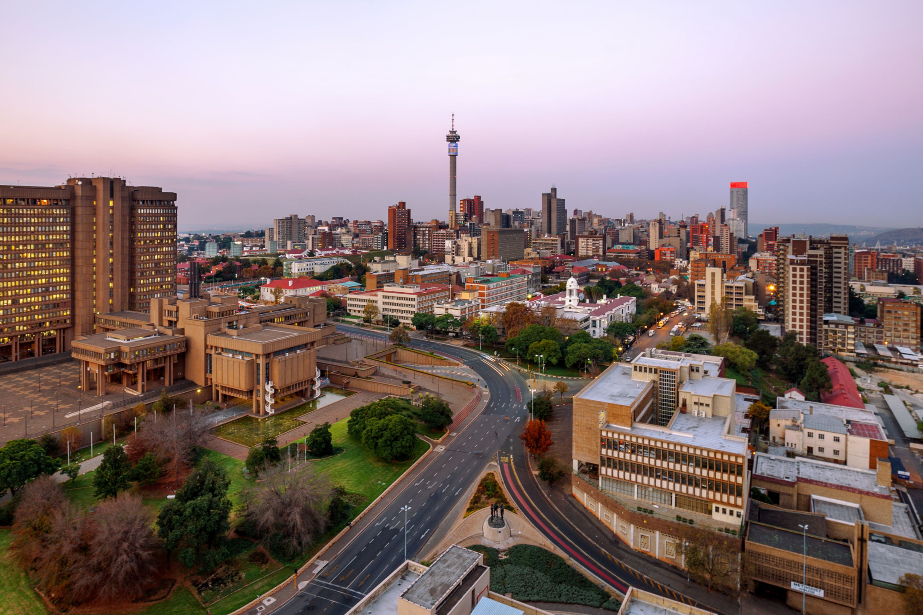 A view of the cityscape of Johannesburg, South Africa, at dusk.