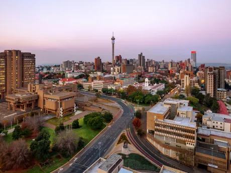 A view of the cityscape of Johannesburg, South Africa, at dusk.