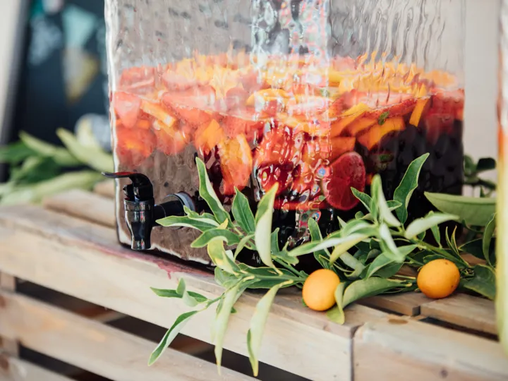 Traditional Spanish Sangria with fruit in a glass jar with tap