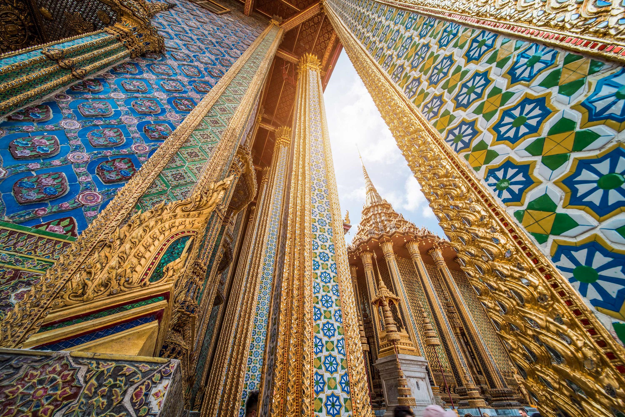 Golden columns and colourful mosaic walls at Wat Phra Kaew Bangkok