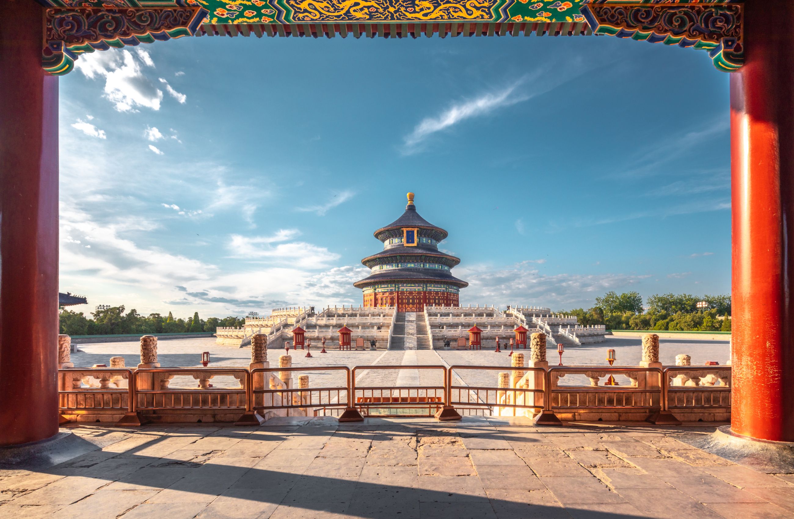 A round temple building with a golden orb on the top of the roof and a long set of steps leading up to it, the Temple of Heaven in China.