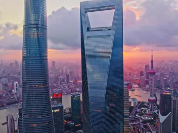 Jinmao Tower and Shanghai skyline against sunset sky, China