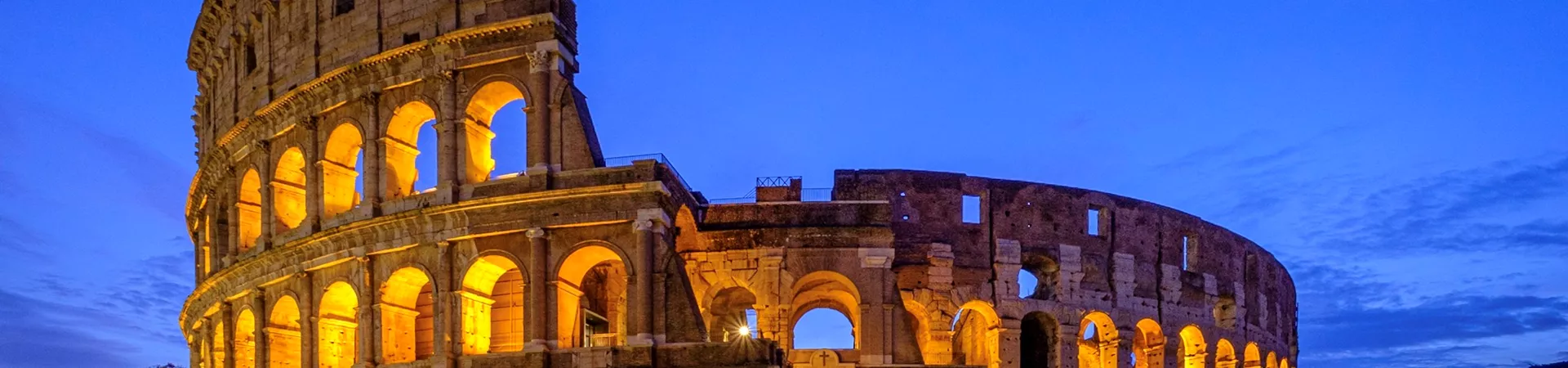 View of coliseum in Rome against blue sky at night
