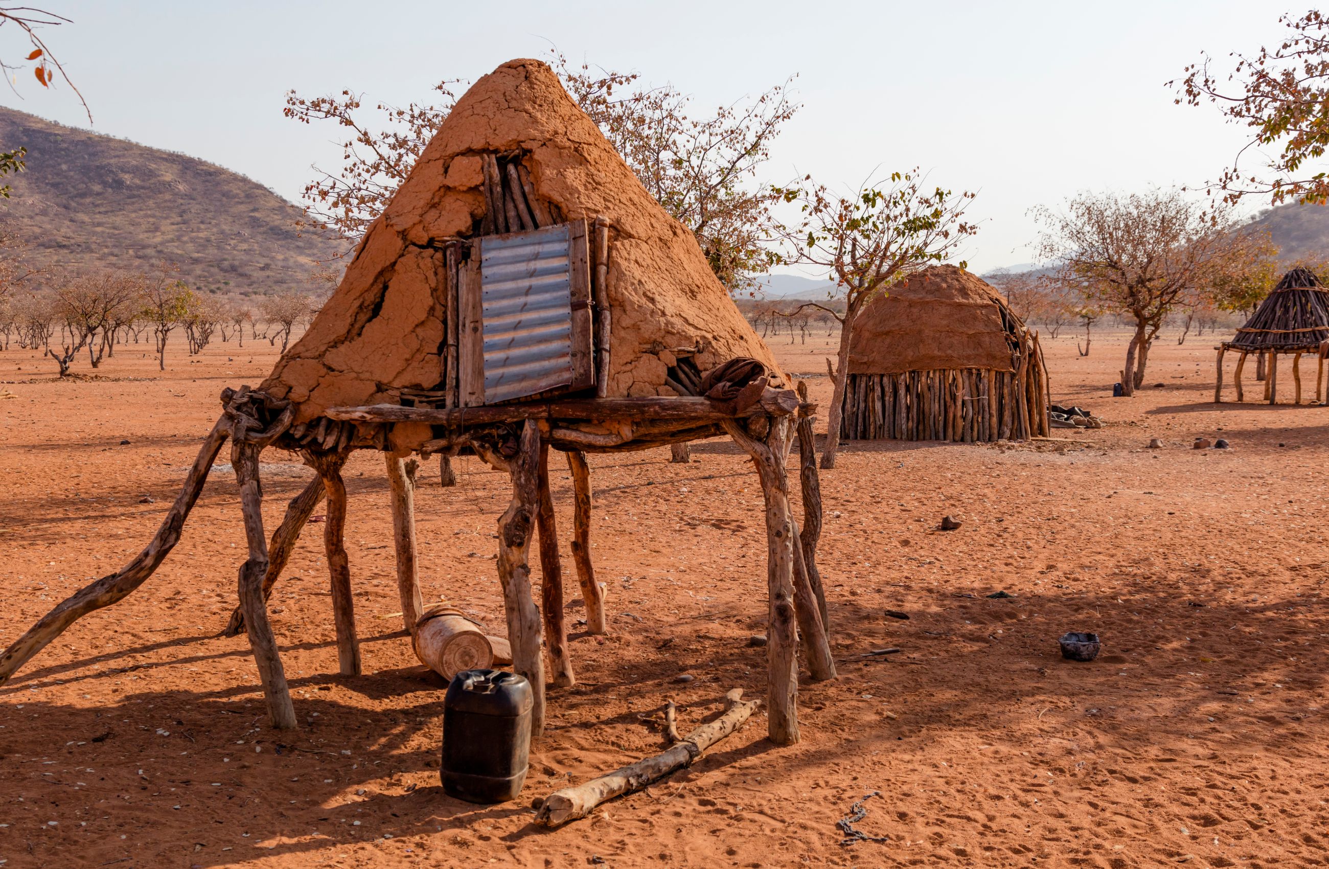 Traditional homes raised off the sandy ground by wooden stakes. Traditional homes of the Herero people of Namibia.