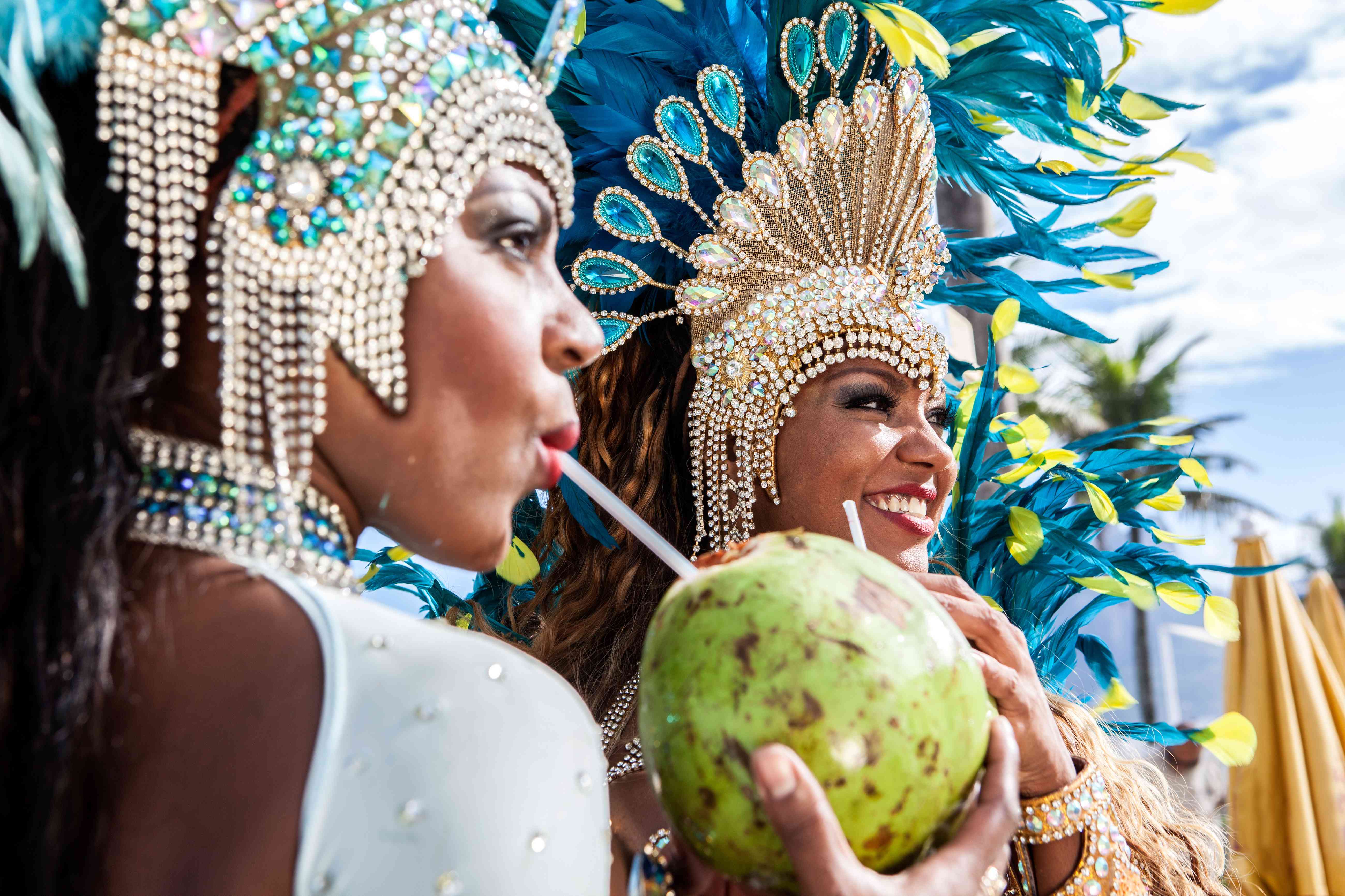 Carnival dancers drinking cocktails out of coconuts in Rio de Janeiro, Brazil